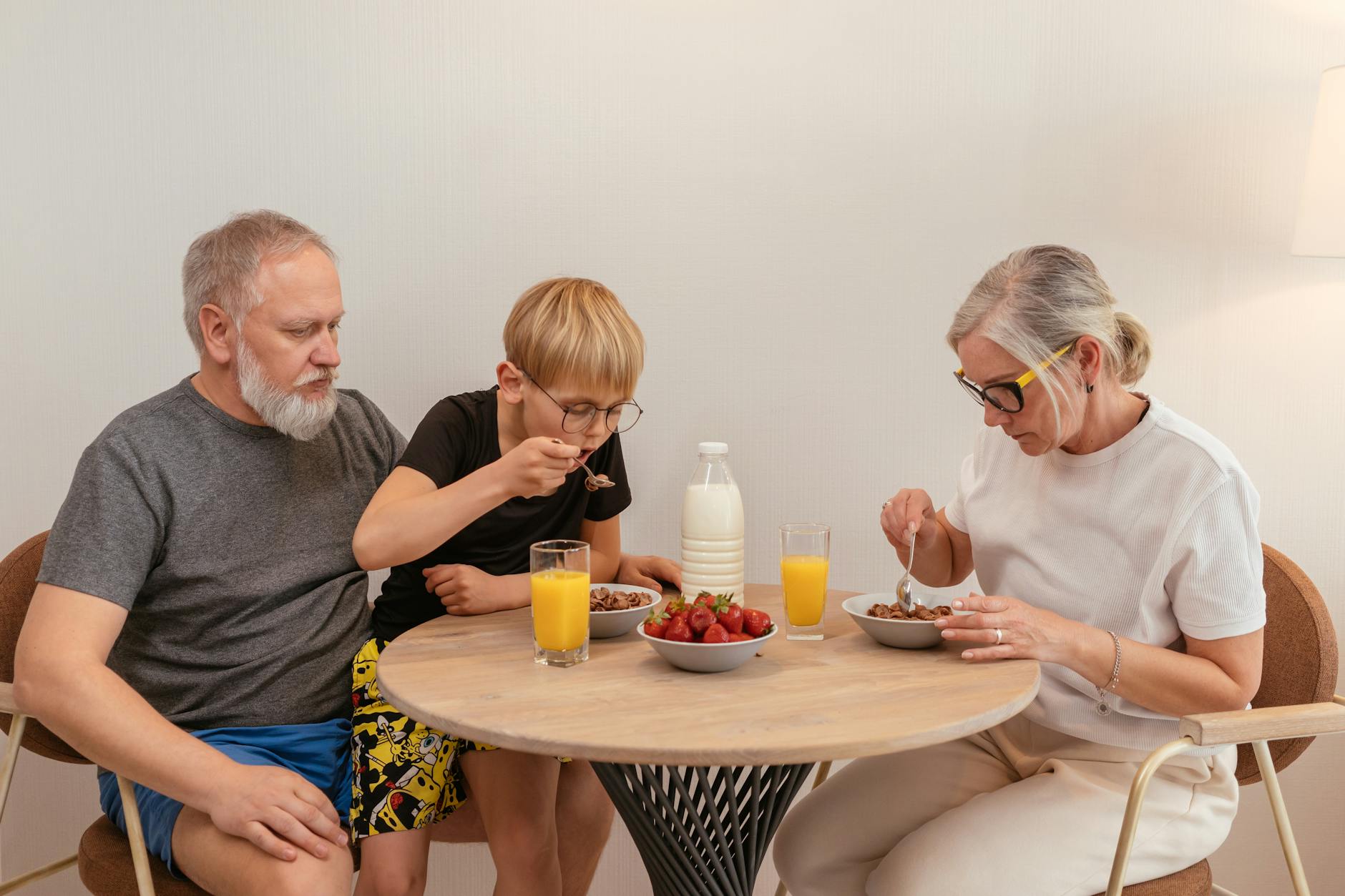 grandparents eating breakfast with their grandson